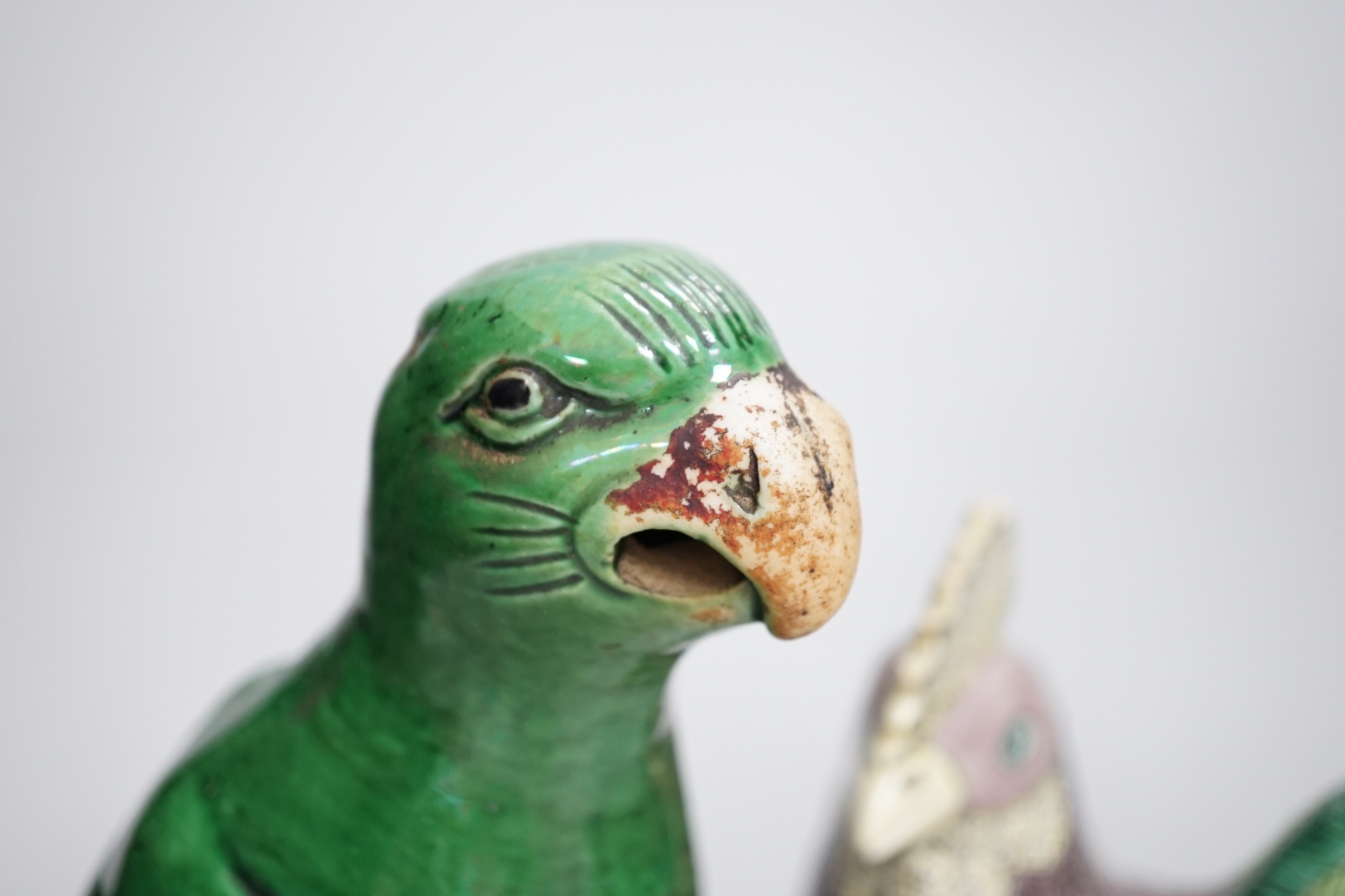A Chinese green glazed model of a parrot, late 19th century and an early 20th century Chinese model of a cockerel, the largest 27cm high